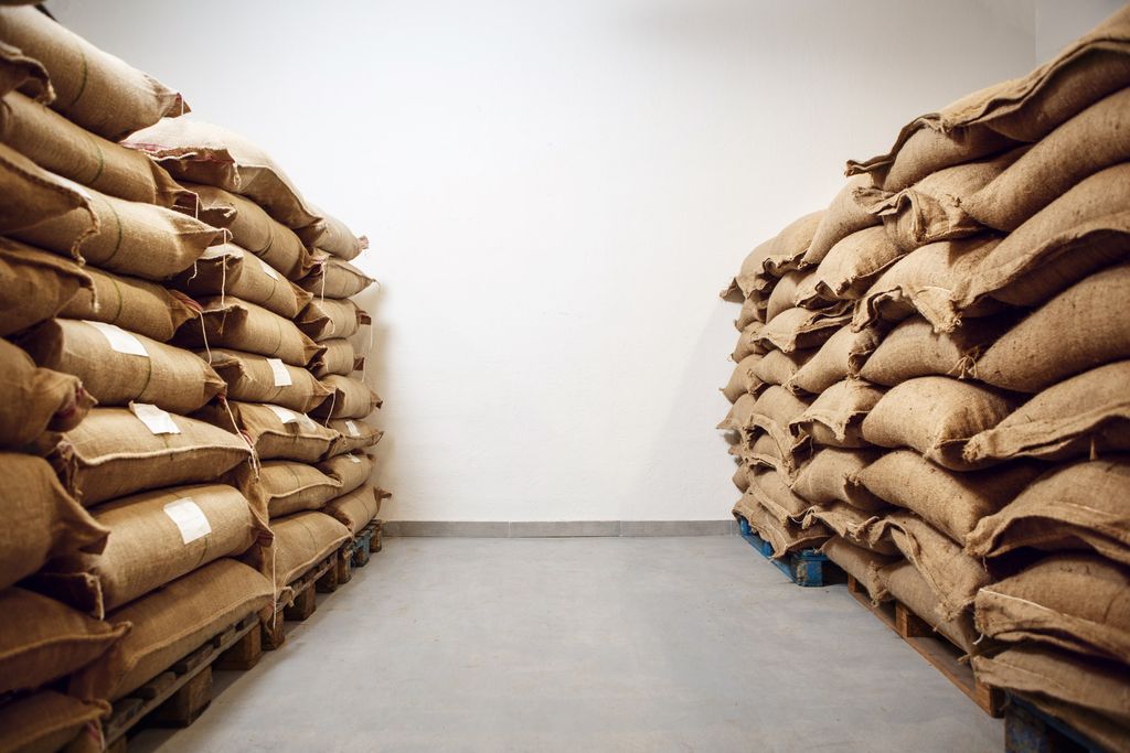 Jute sacks stacked on pallets in a clean, orderly warehouse