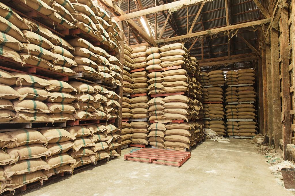 Jute sacks stacked on pallets in a warehouse